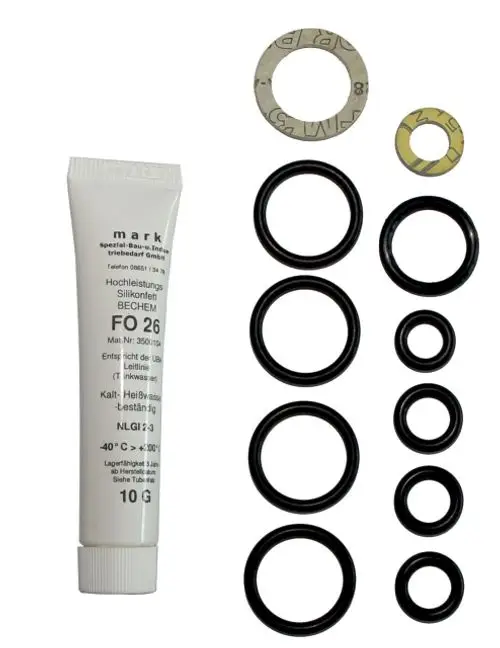 Dichtungsset mit verschiedenen O-Ringen und Silikonfett, geeignet für hydraulische Anwendungen, Marke Wolf. Alle Teile übersichtlich angeordnet.